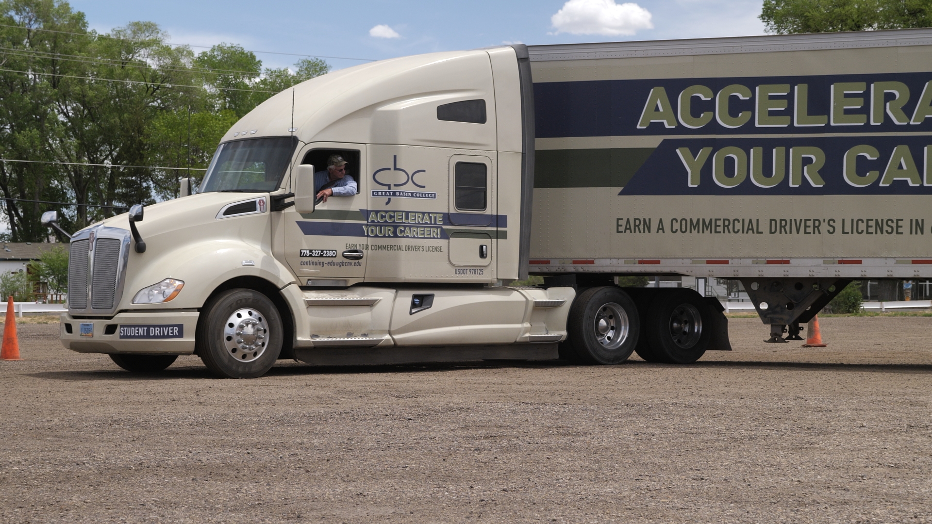 GBC commercial driver driving a truck with "Accelerate Your Career" branding on truck